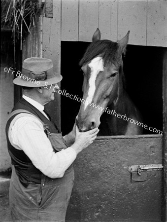 GENT WITH RACEHORSE AT STABLE